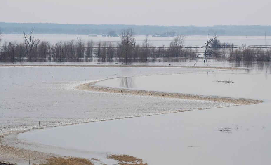 Water flows over a southwest Iowa levee in March. Repairs to the L575B levee near Hamburg, a corps priority, could take another six weeks. RYAN SODERLIN/THE WORLD-HERALD