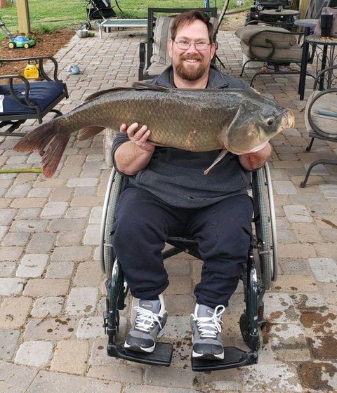 Nathan Keck of North Platte with his master angler bigmouth buffalo carp. "I was pretty happy," he said after the surprise catch. "I was worn out." COURTESY PHOTO