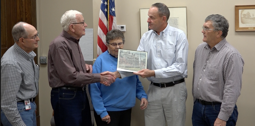 Fairbury mayor Homer Ward receives a certificate of appreciation from Jefferson County Commissioner chairman Mark Schoenrock on Tuesday. Homer's wide, Maxine (middle) was also present.