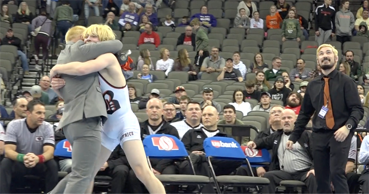 Beatrice sophomore wrestler Trevor Reinke embraces head coach Jordan Johnson after his ultimate tiebreaker win over No. 3 Bryce Brown of Hastings.