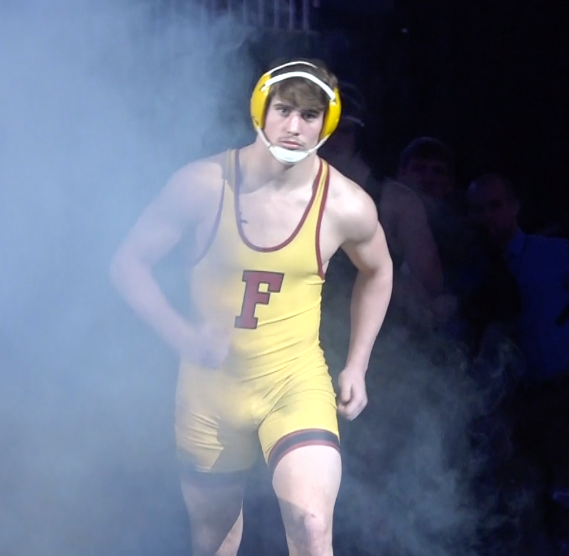 Fairbury wrestler Seth Firmanik enters the floor before his championship match.