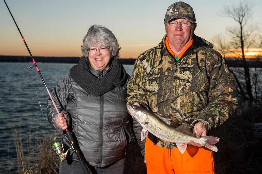 Kim, at right, and Ladell Earney of Chadron pose with a walleye Ladell caught on a late March evening at Whitney Reservoir in Dawes County.
