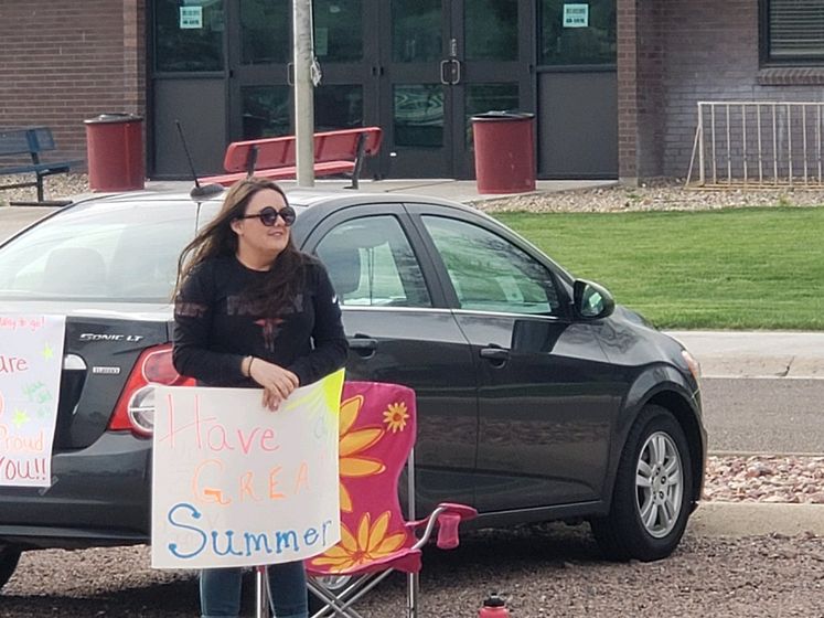 West Elementary Teacher Ms. Regan Hinton displays a "Have a Great Summer" sign Tuesday evening.