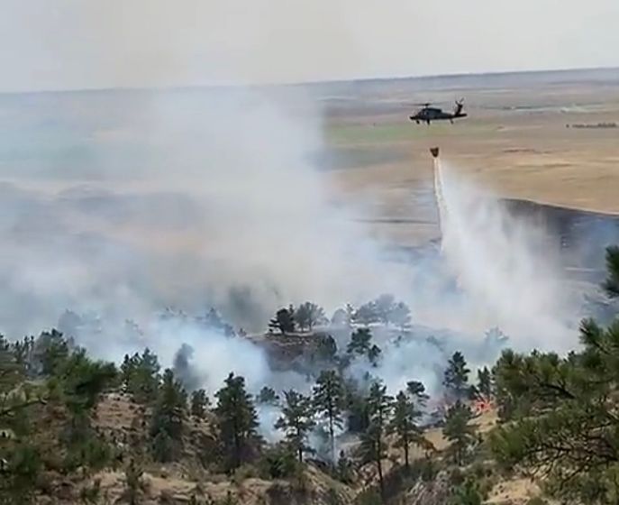 An air tanker dowses a wildfire in Banner County on Friday, Aug. 28, 2020.