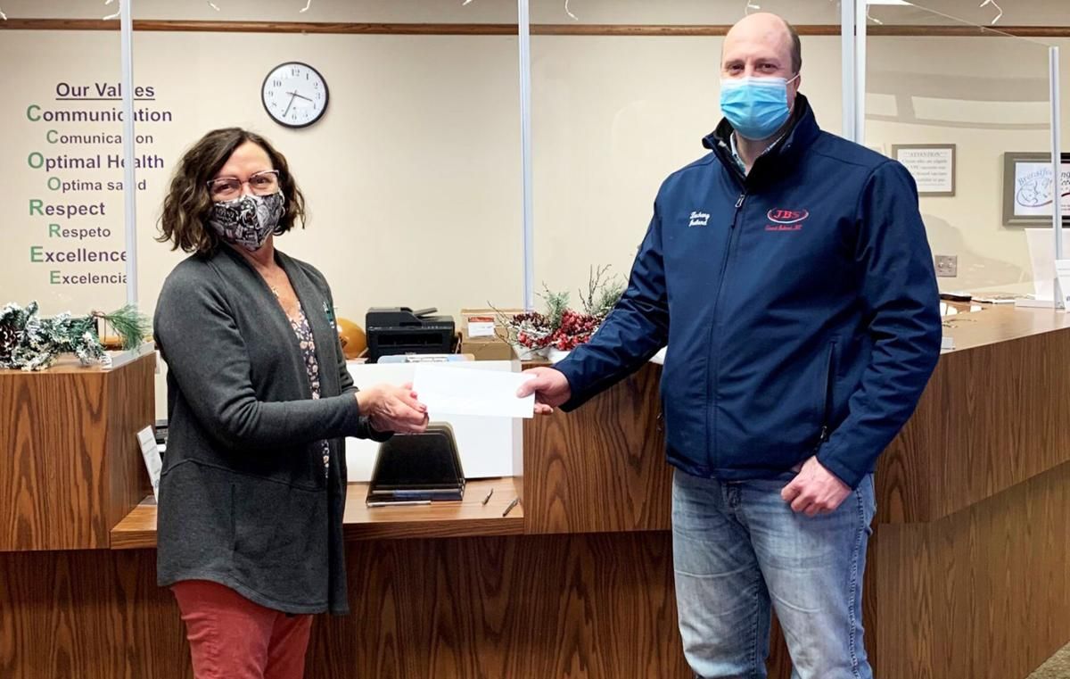 Justin Bstandig of JBS presents a $10,000 check to Teresa Anderson of CDHD.