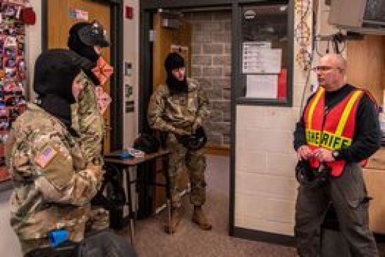 Nebraska Army National Guard members go over training exercises during an active training session at Chadron High School on Jan. 9, 2021.