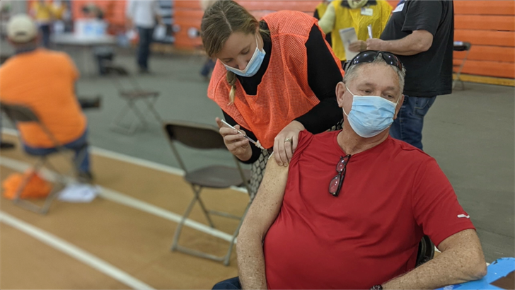 Jerry Brueggeman receives his shot at the PHS vaccine clinic at Doane University.