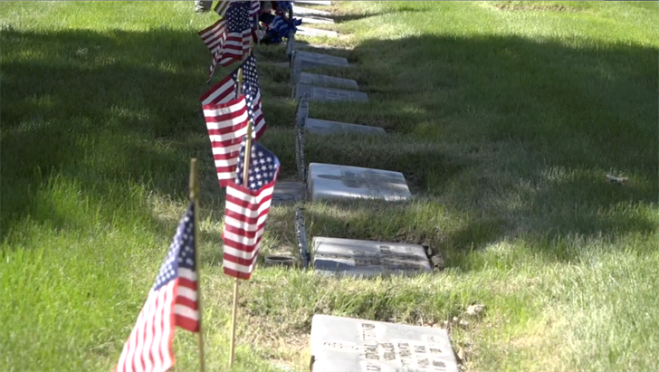 American flags sit at the grave sites of U.S. military service members at Sidney's Greenwood Cemetery ahead of Memorial Day in 2020.