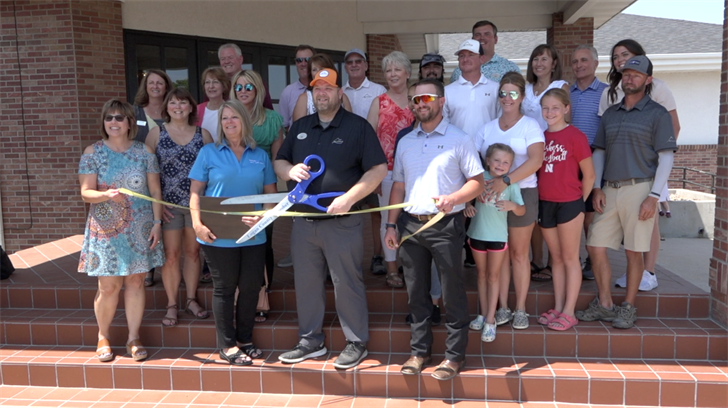 Representatives from Sky Ranch Golf Course and the Logan County Chamber of Commerce pose before the ribbon cutting at the golf course. Photo by Elic Chisam