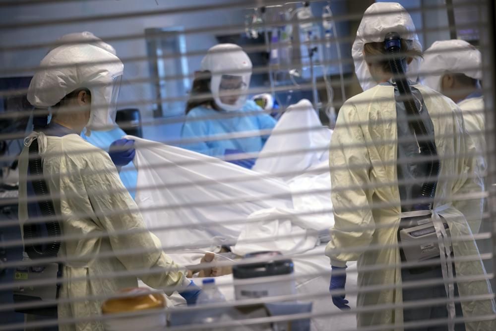 In this image provided by the University of Utah Health, medical professionals look after a COVID-19 patient in the intensive care unit on July 30, 2021, in Salt Lake City. The U.S. death toll from COVID-19 has surpassed 700,000.