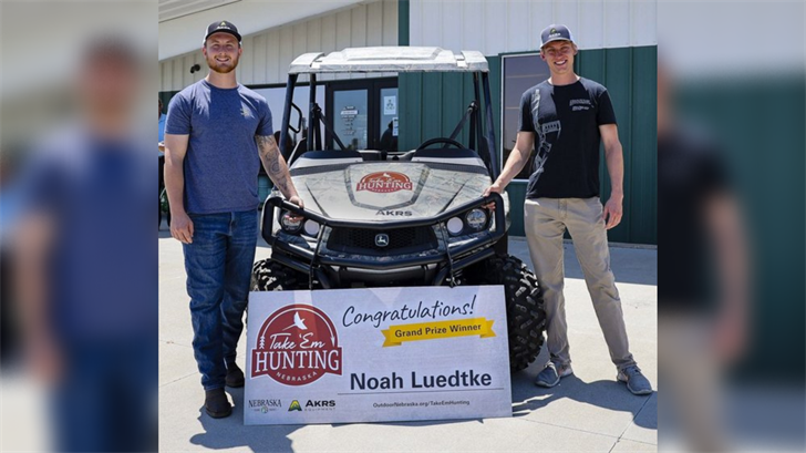 Noah Luedtke, left, won a John Deere Gator utility vehicle, donated by AKRS Equipment for introducing his friend, Preston Cuddy, right, to hunting in the Take ’em Hunting challenge.
