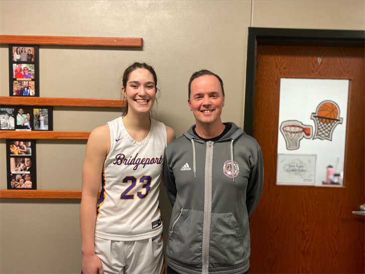 Bridgeport senior Ruthie Loomis-Goltl reached 2,000 career points in the Bulldogs victory over Chase County in the C1-12 Sub-District Championship game on Thursday, Feb. 16, 2023. She's pictured with Head Coach Dave Kuhlen.